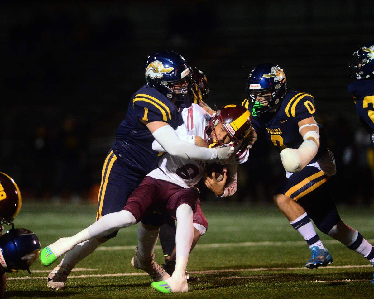 Turlock’s Owen Miller (1) and Logan Bankson (0) sack Edison quarteback Berell Staples during a CIF Division I CIF Sac-Joaquin Section Football Playoff game between Turlock High School and Edison High School at Turlock High School in Turlock CA on November 4, 2022. Turlock won 35-0.
