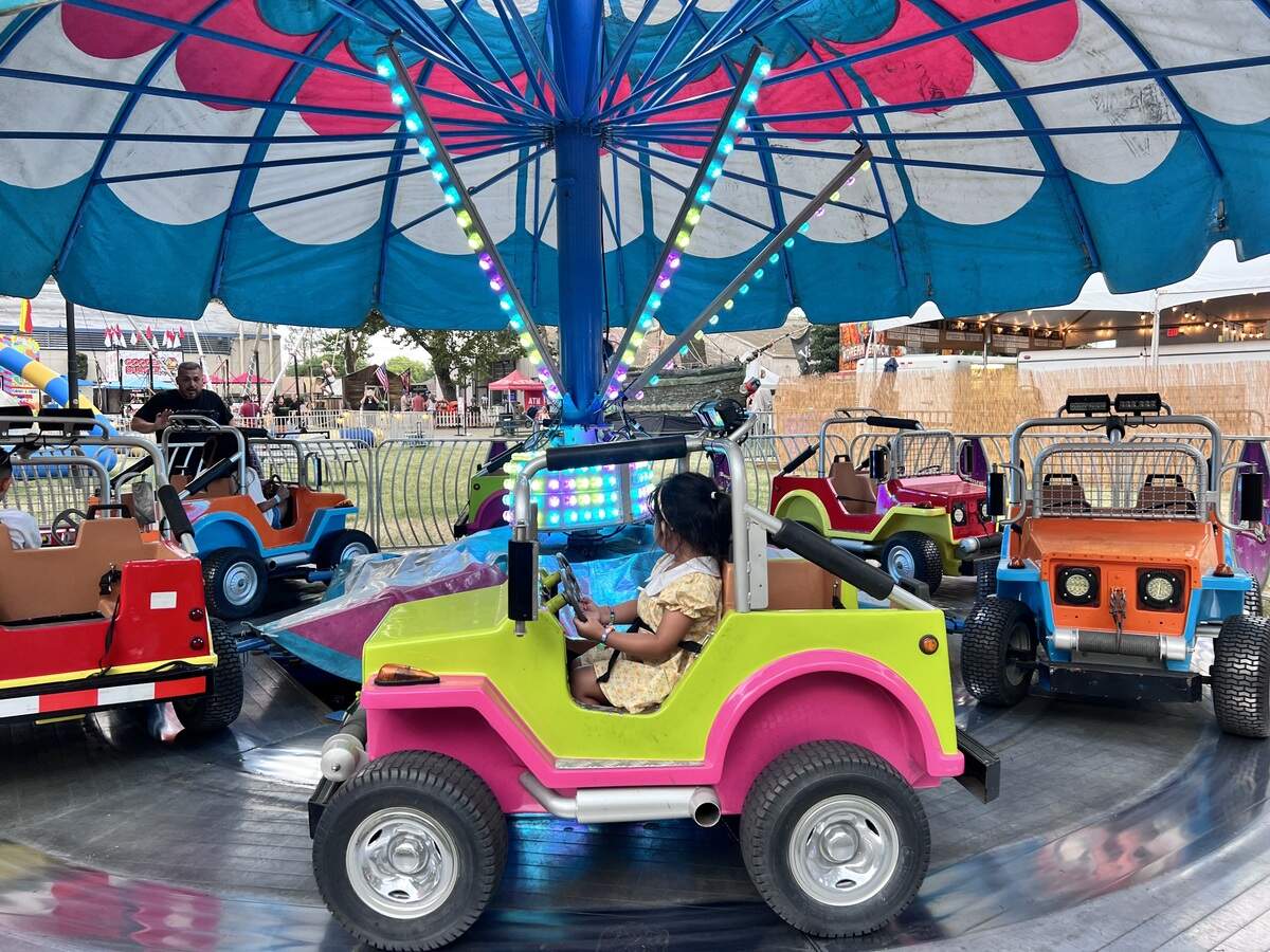 Aurora Garcia, 4, rides on the children’s car carousel at the Stanislaus County Fair in Turlock, California.