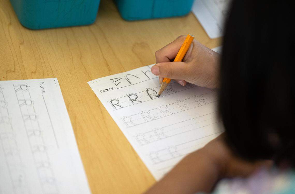 Student Enriava Fernandez works on a handwriting exercise in transitional kindergarten class at Fremont School in Modesto , Calif., Thursday, Dec. 7, 2023. The kindergarten students are working on motors skills and letter recognition to prepare them for cursive writing in later grades. In October, Gov. Gavin Newsom signed a law requiring cursive handwriting instruction mandatory in first through sixth grades effective Jan. 1.