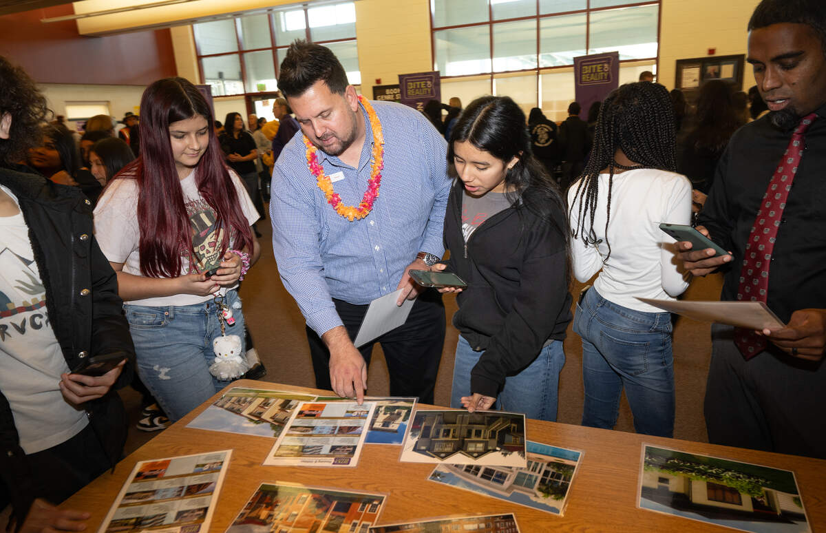 Randy Icelow, a lending vice president at Mosce Credit Union, middle left, helps students purchase or rent a home during an after school financial literacy event at Glick Middle School in Empire, Wednesday, Dec. 11, 2024.
