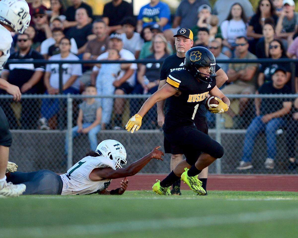 Hughson running back Alexander Villarreal cuts up field after evading a Central Valley defender during a game between Hughson High School and Central Valley High School at Hughson High School in Hughson California on August 25, 2023.