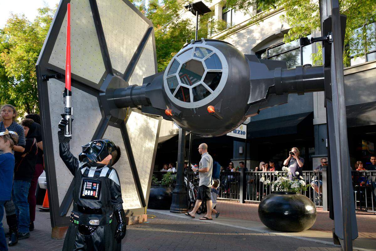 May The Fourth Star Wars Day brought out hundreds to Tenth Street Place May 4, 2018 in Modesto, Calif. The free public event included Star Wars cosplayers, live music and a performance by the Beyer High band. A little Darth Vader poses in front of a custom-built TIE-fighter.