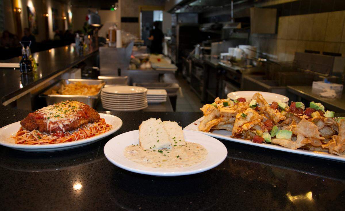 Chicken parmesan, clam chowder and poke nachos served at Midtown Bistro Jan. 15, 2021 in Modesto, Calif.