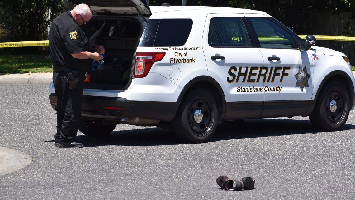 Armando Osuna's shoes lie on Burneyville Road in Riverbank as the Stanislaus County Sheriff's Department investigates the officer-involved shooting that killed him Tuesday, May 29, 2018. The shooting occurred on a residential property on the east side of Burneyville.