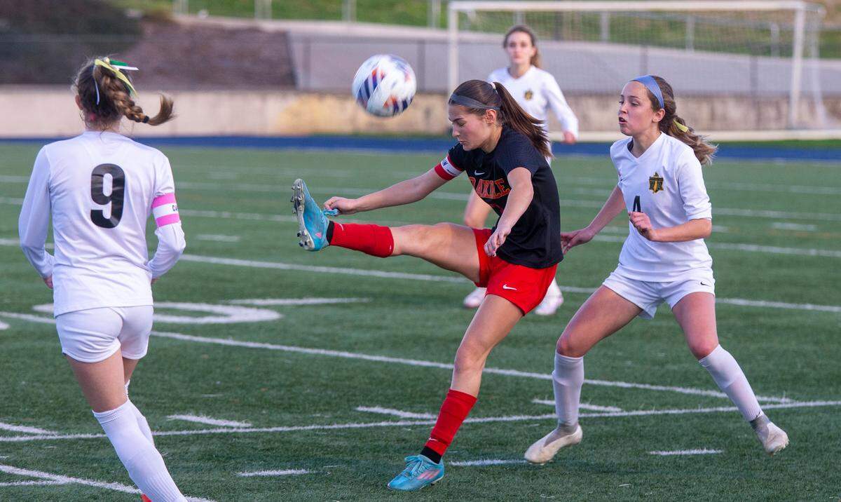 Oakdale High’s Mia Peterson, 3, kicks the ball over her head during the Sac-Joaquin Section Division III Section Championship match against Rio Americano Thursday Feb. 22, 2024 at Cosumnes River College.