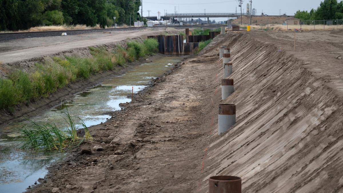 A coffer dam will divert water for the construction of a concrete box culvert to be installed along rail tracks in Lathrop to allow for a new rail connection for the Stanislaus County lines of the Altamont Commuter Express (ACE) train. Photographed in Lathrop, Calif., Tuesday, June 18, 2024.