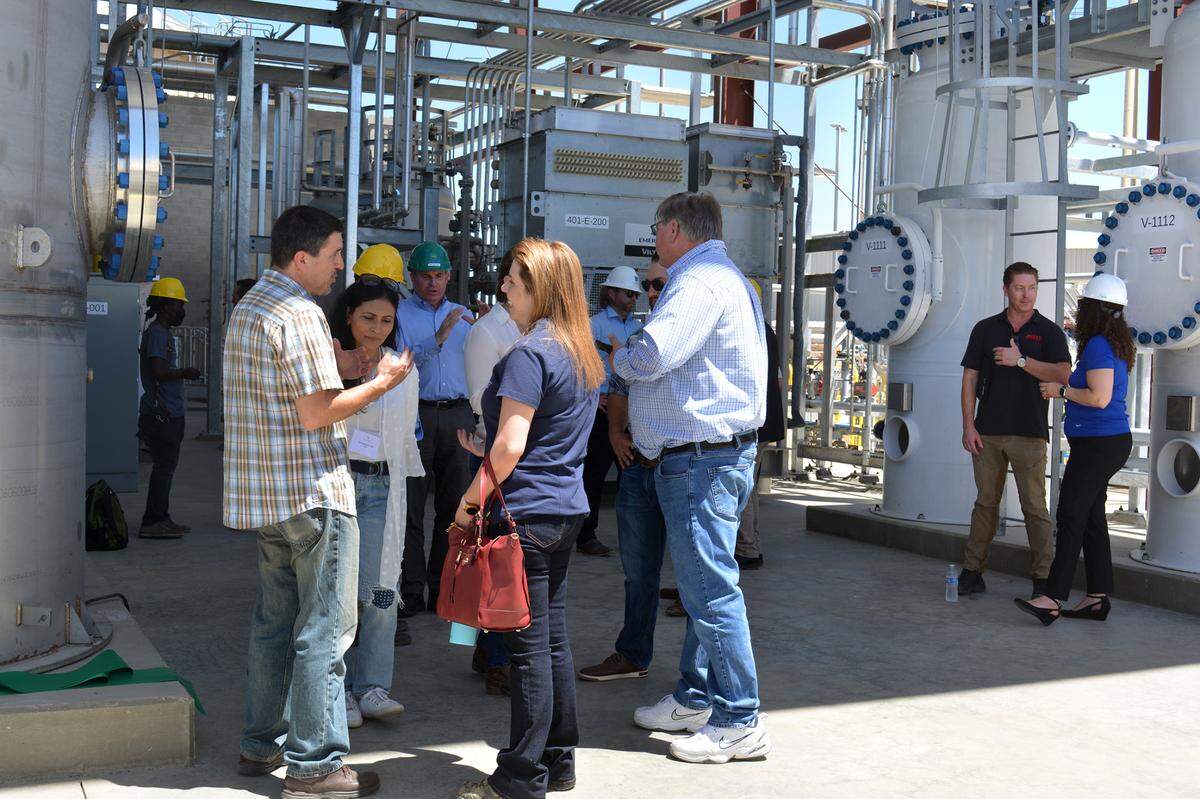 Guests mingle at the June 10, 2022, ribbon-cutting for an Aemetis plant that will feed methane from dairy manure into PG&E gas lines in Keyes CA.