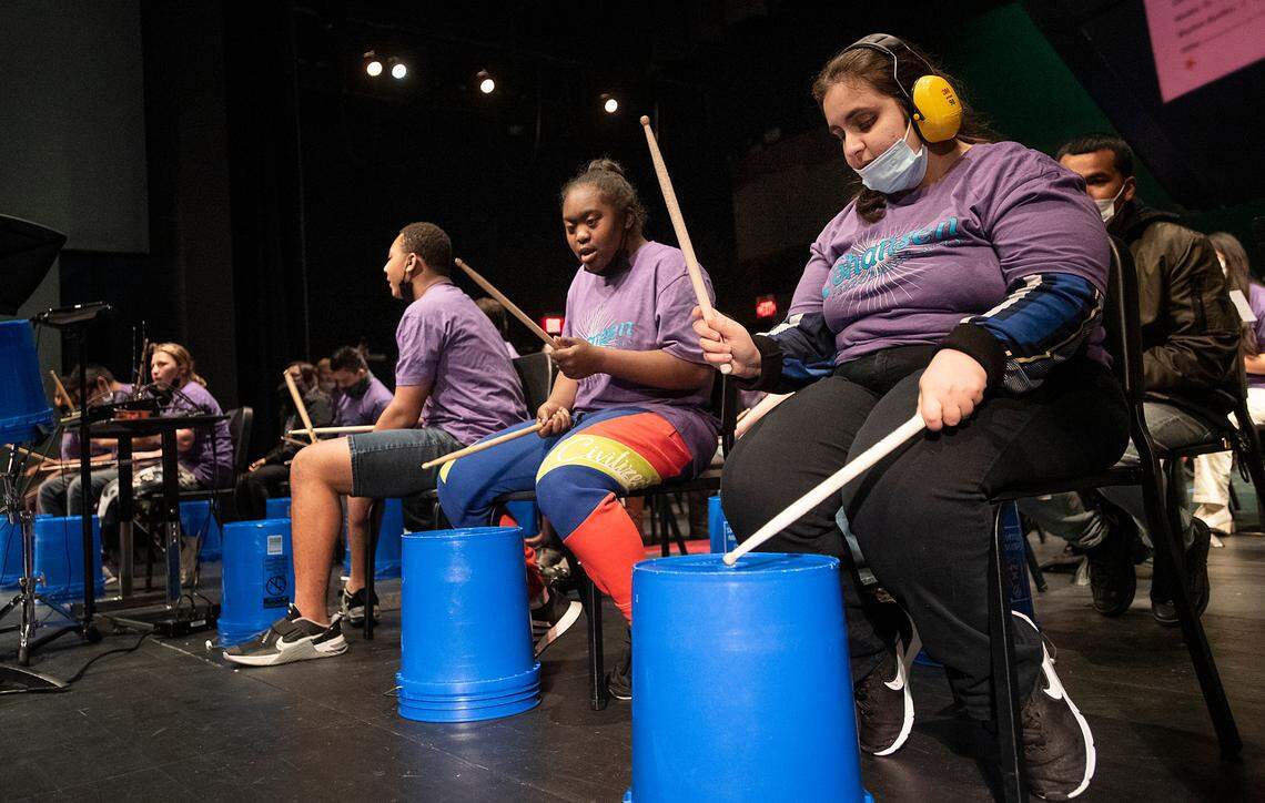 Special education students Rita Elia, right, an Rahjae Davis, middle, play the drums with music and other special education students at Johansen High School collaborated to present a “Differently-Abled Drumline Celebration.” in Modesto, Calif., on Friday, Dec. 17, 2021.