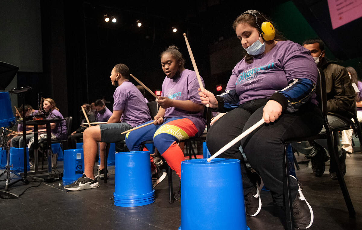 Special education students Rita Elia, right, an Rahjae Davis, middle, play the drums with music and other special education students at Johansen High School collaborated to present a “Differently-Abled Drumline Celebration.” in Modesto, Calif., on Friday, Dec. 17, 2021.