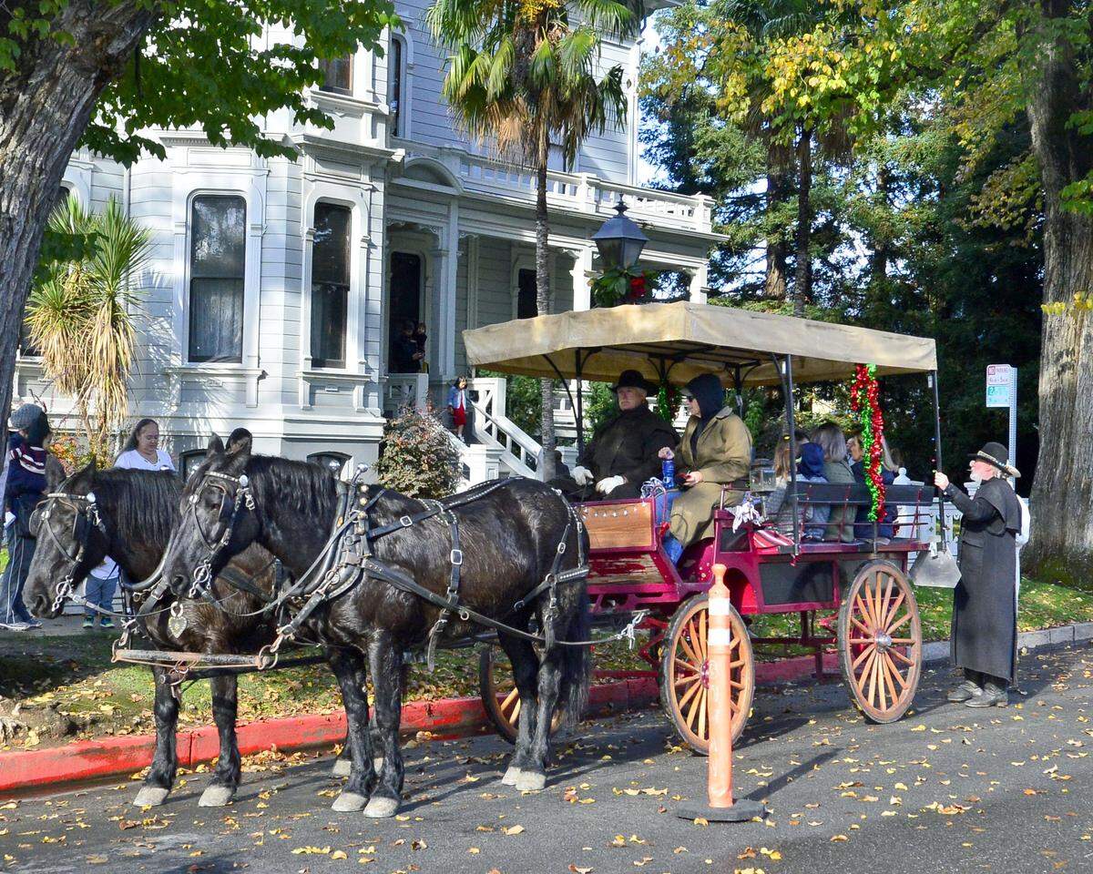A horse drawn carriage gets loaded with passengers in front of the McHenry Mansion during the Dickens Faire in Downtown Modesto on December 1, 2018. 