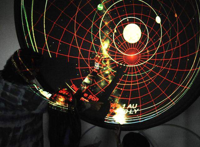 Visitors in the planetarium look at a map of the solar system, during a past year’s Stanislaus State Science Day.