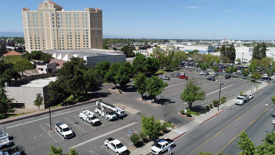 The site for the proposed high-end hotel on 11th street between K and L streets in downtown Modesto, Calif. is pictured from the Bee’s drone on Wednesday April 17, 2019.The site is in the Modesto Centre Plaza’s parking lot.The hotel would complement the 258-room Doubletree by Hilton Hotel, pictured here at back left.