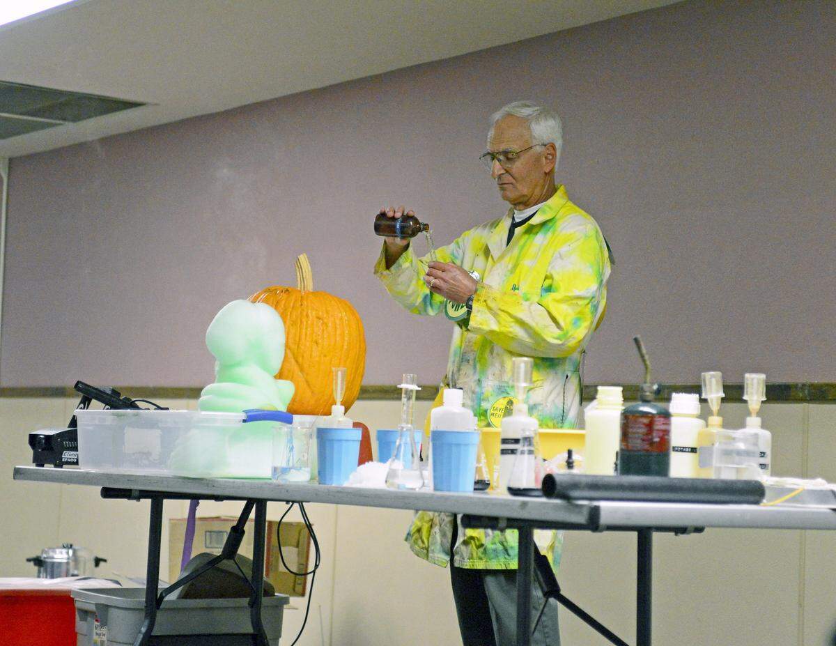 Dr. Steve Murov pours a liquid substance mix for to create  Elephant Toothpaste, this liquid when mixed correctly makes rapidly expanding green form. He did this as part of his presentation at Exploratorium Night at Johansen High School on Wednesday night (02/19/14).    