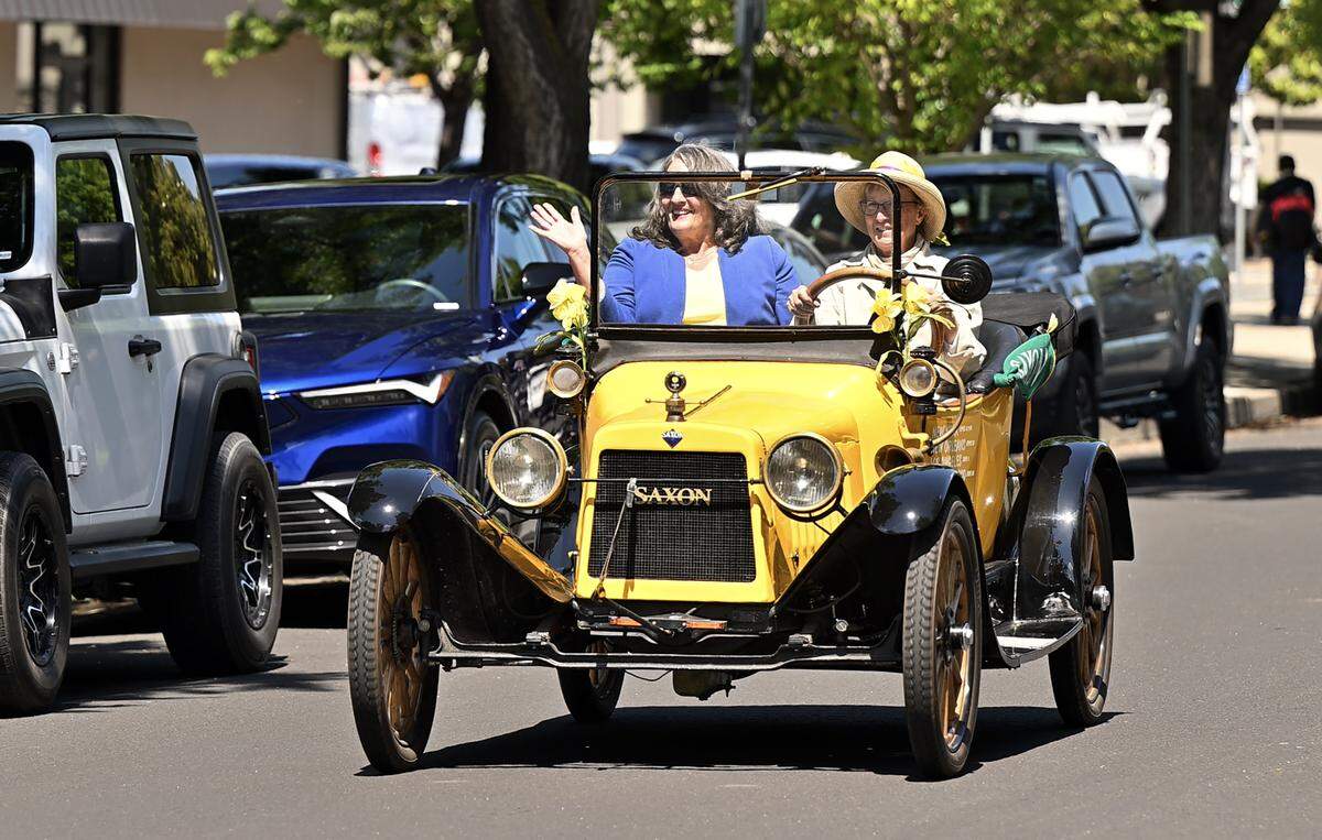 Modesto mayor Sue Zwahlen rides with Susan Nourse in a Saxon motor car used in the 1916 suffrage tour. Driving the Vote for Equality Tour visited Modesto, May 6, 2026 and is retracing the route made by suffragettes Nell Richardson and Alice Burke in 1916.