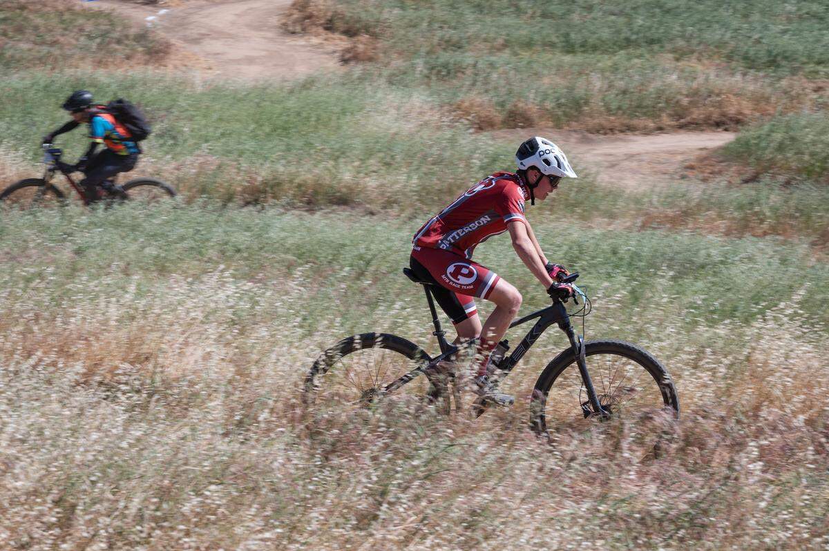 Patterson team member Elijah Jamieson, right, competes in the boys sophomore division II mountain bike race at Tuolumne River Regional Park during the NorCal Interscholastic Cycling League event in Modesto, Calif., on Saturday, April 9, 2022. Jamieson finished 14th out of 41 riders.