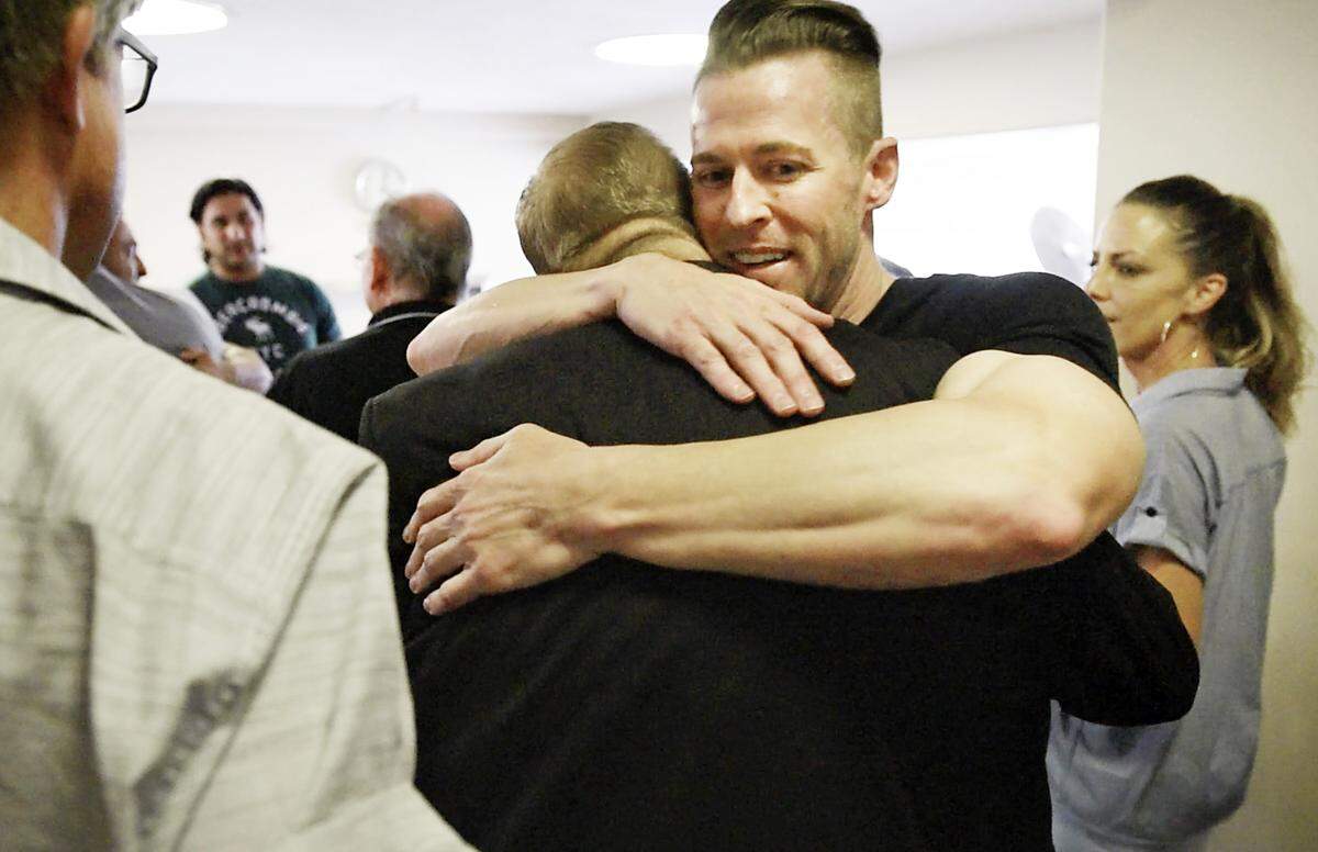 Walter Wells hugs Modesto attorney Frank Carson in a courthouse hallway moments after a Stanislaus County jury on June 28, 2019, found Carson and two others not guilty of murder in the death of Korey Kauffman.