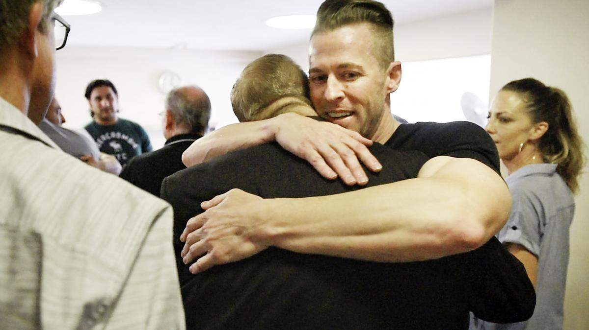 Walter Wells hugs Modesto attorney Frank Carson in a courthouse hallway moments after a Stanislaus County jury on June 28, 2019, found Carson and two others not guilty of murder in the death of Korey Kauffman.