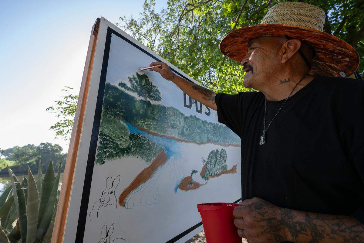 Grayson artist Jose Munoz works on a mural during the opening of Dos Rios State Park in Modesto, Calif., Wednesday June 12, 2024.