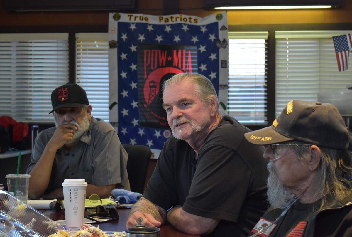 At a May 15 meeting of the True Patriots veterans support group in Modesto, co-founder Jerry Wood, center, talks to Eli Price (not pictured). To Wood’s right is co-founder and President Carlos Lara. To his left is member Walt Cupid.