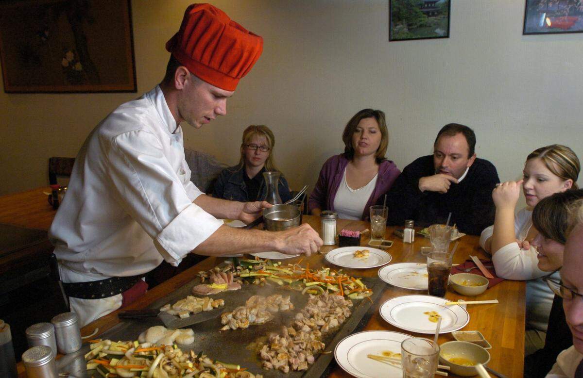 The teppanyaki grill at Torii Japanese Restaurant in Century Center shopping center in Modesto, Calif. (L-R): Chef Travis Lawerence cooking for large group in Bee file photo from Nov. 1, 2004.