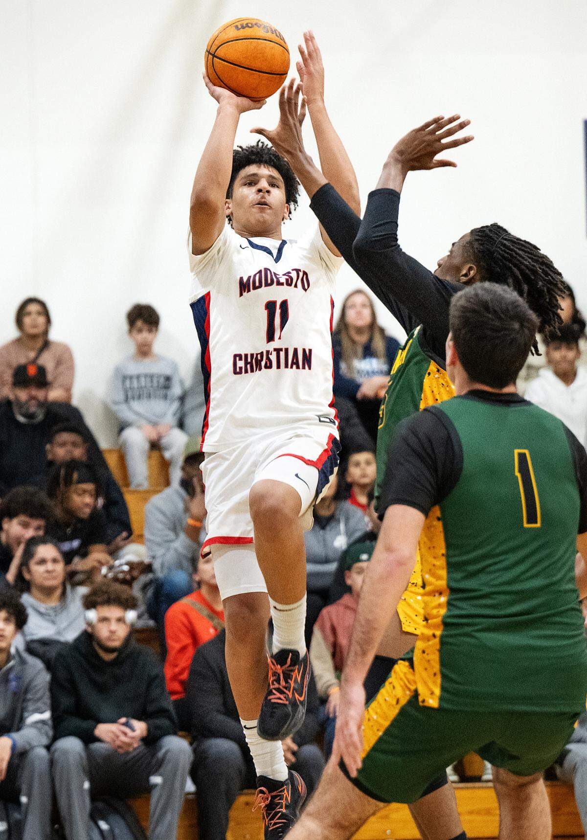 Modesto Christian’s Gavin Sykes fires a jump shot during the Holiday Hoop Classic championship game with Vanden at Modesto Christian High School in Salida, Calif., Saturday, Dec. 30, 2023. Modesto Christian won 68-61.