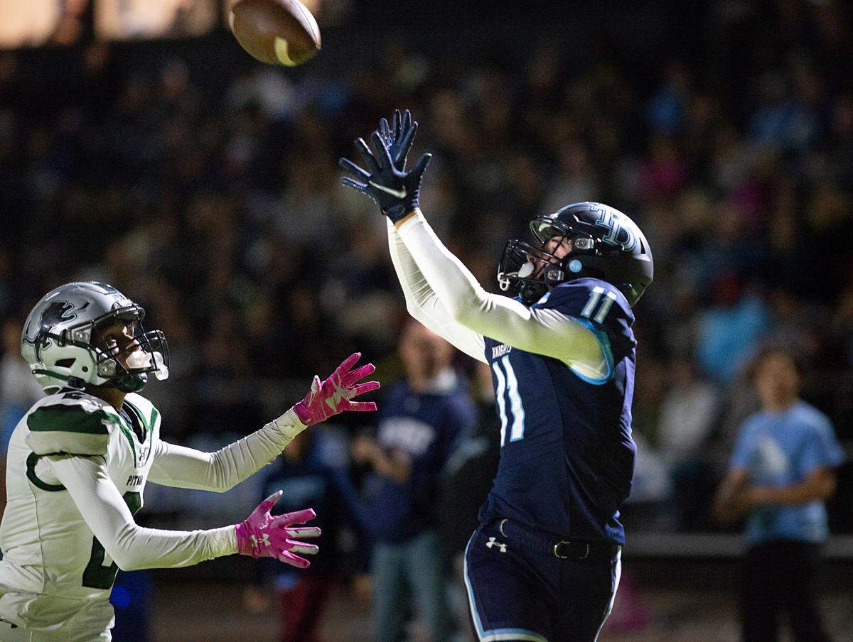 Downey’s Ethan Woodmansee makes a catch in the end zone over Pitman defender Carlos Naranjo during the Central California Athletic League game at Downey High School in Modesto, Calif., Friday, Oct. 28, 2022.