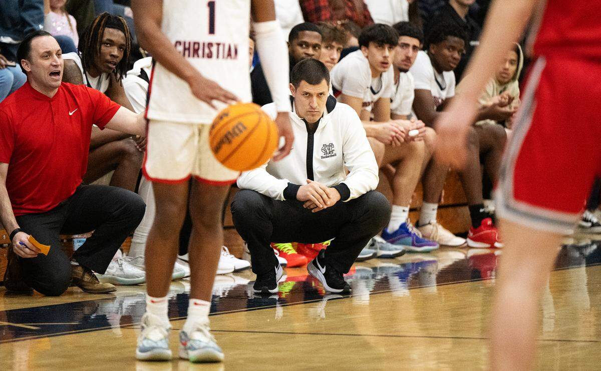 Modesto Christian coach Brice Fantazia, middle, watches the action in the first half of the Tri-City Athletic League game with Lincoln at Modesto Christian High School in Salida, Calif., Friday, Jan. 12, 2024.