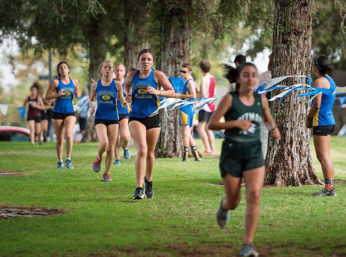 Members of the Turlock varsity team run the second lap during the CCAL meet at Donnelly Park in Turlock, Calif., on Wednesday, Oct. 3, 2018. Turlock finished 5th in the team results.