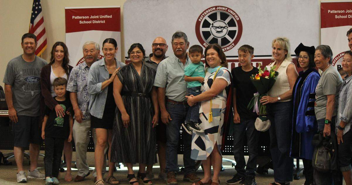 Corrin Rivera (middle right) stands next to her family for a photo following the ceremony.