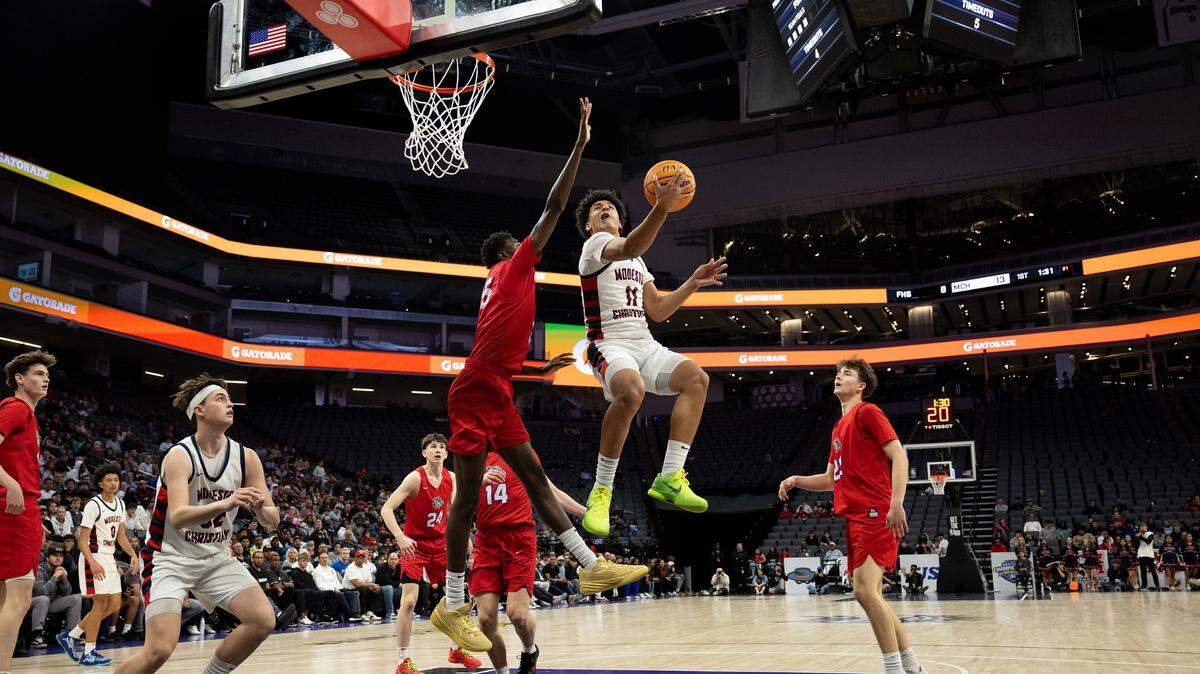 Modesto Christian guard Gavin Sykes draws a foul from Folsom’s Siyahe Siaisiai during the Sac-Joaquin Section Division 1 championship game at the Golden 1 Center in Sacramento, Friday, Feb. 28, 2025. Folsom won the title 62-52.