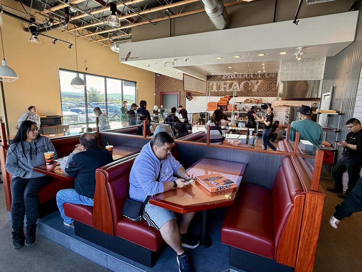 Diners fill Pizza My Heart in Tracy during its soft opening phase.