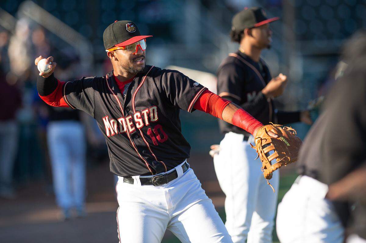 Modesto Nuts firstbaseman Robert Perez Jr. warms-up before the California League game with the Stockton Ports at John Thurman Field in Modesto, Calif., on Wednesday, July 6, 2022.