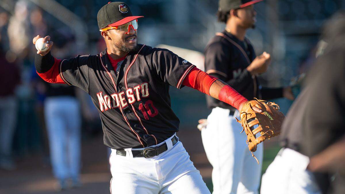 Modesto Nuts firstbaseman Robert Perez Jr. warms-up before the California League game with the Stockton Ports at John Thurman Field in Modesto, Calif., on Wednesday, July 6, 2022.