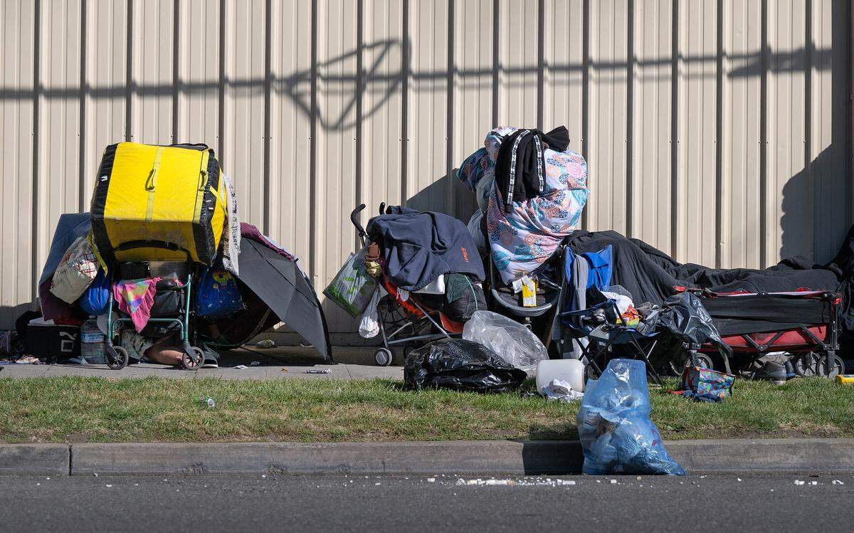Homeless people make camp on a K Street sidewalk in Modesto in May of 2023.