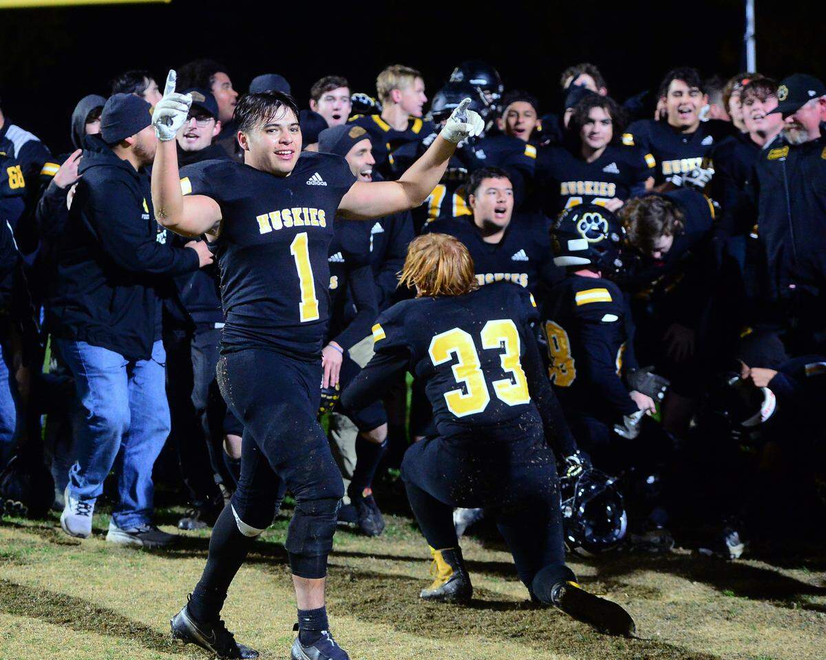 Hughson running back Alex Villarreal (1) celebrates with his team after a Sac-Joaquin Section Division VI football playoff game between Hughson High School and Orestimba in Hughson on Nov. 18, 2022. Hughson won the game 21-17.