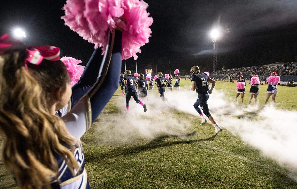 Central Catholic players take the field before the Valley Oak League game with Manteca at Central Catholic High School in Modesto, Calif., on Friday, Oct. 15, 2021.