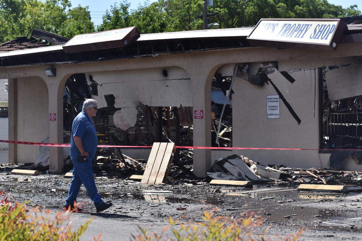 Chuck Wells, owner of Jay’s Trophy Shop, on Saturday June 8, 2019, walks near the business his father started in 1980. A fire destroyed the business at the shopping center in the 1100 block of Carver Road in Modesto, California.