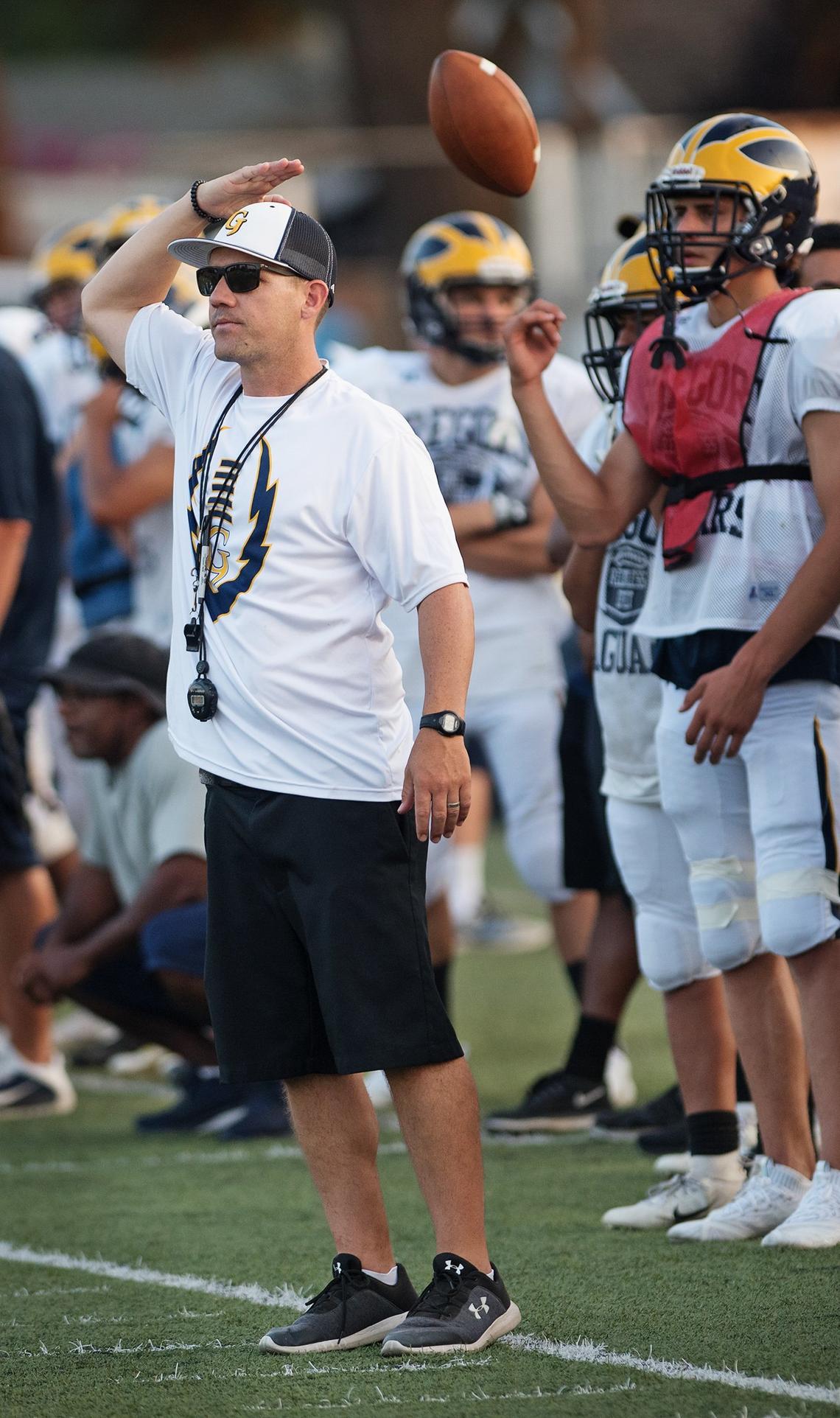 Gregori coach Jason McCoy signals for the sideline during a preseason scrimmage at Downey High School in Modesto, Calif., Friday, August 10, 2018. 