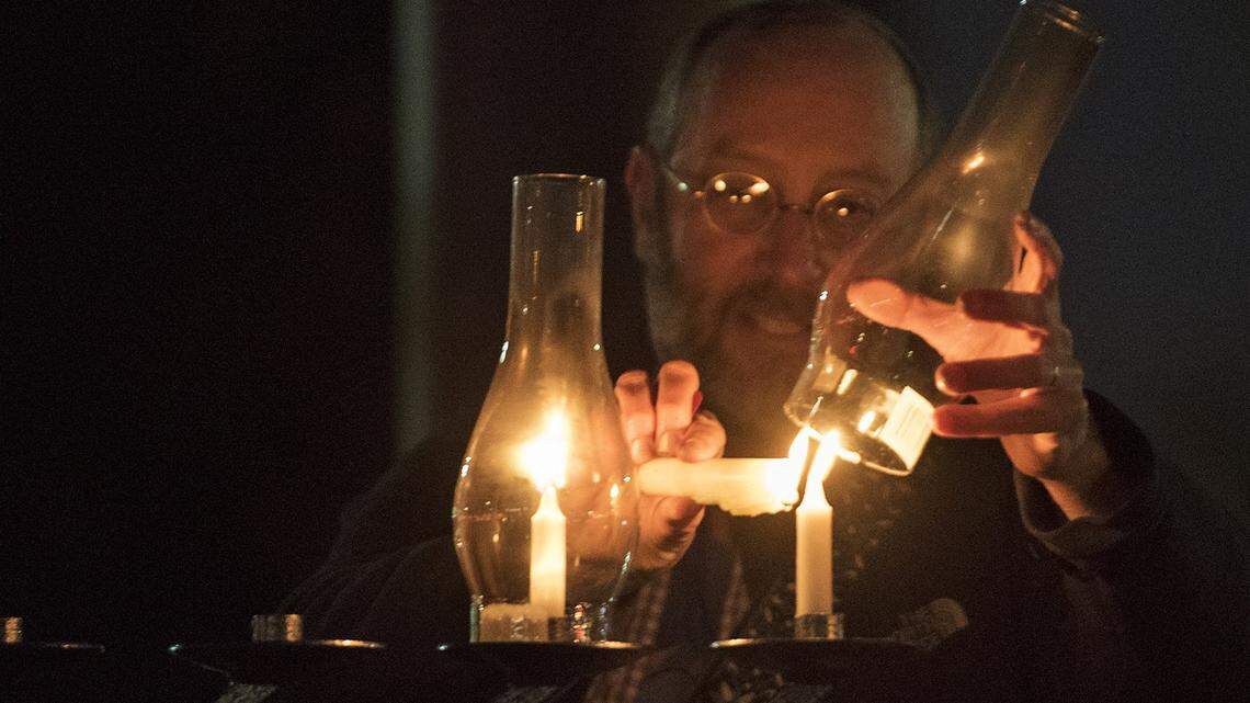 Congregation Beth Shalom Rabbi Shalom Bochner lights the Hanukkah menorah at Modesto’s McHenry Village in 2017.