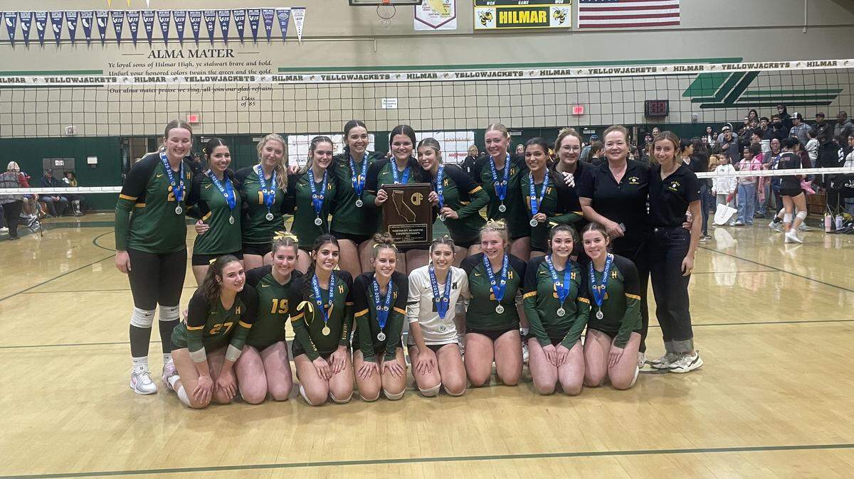 The Hilmar High volleyball team poses with the championship plaque after winning the CIF Northern California Regional Division V title in four sets over Colusa on Tuesday, Nov. 18, 2025 in Hilmar, Calif.