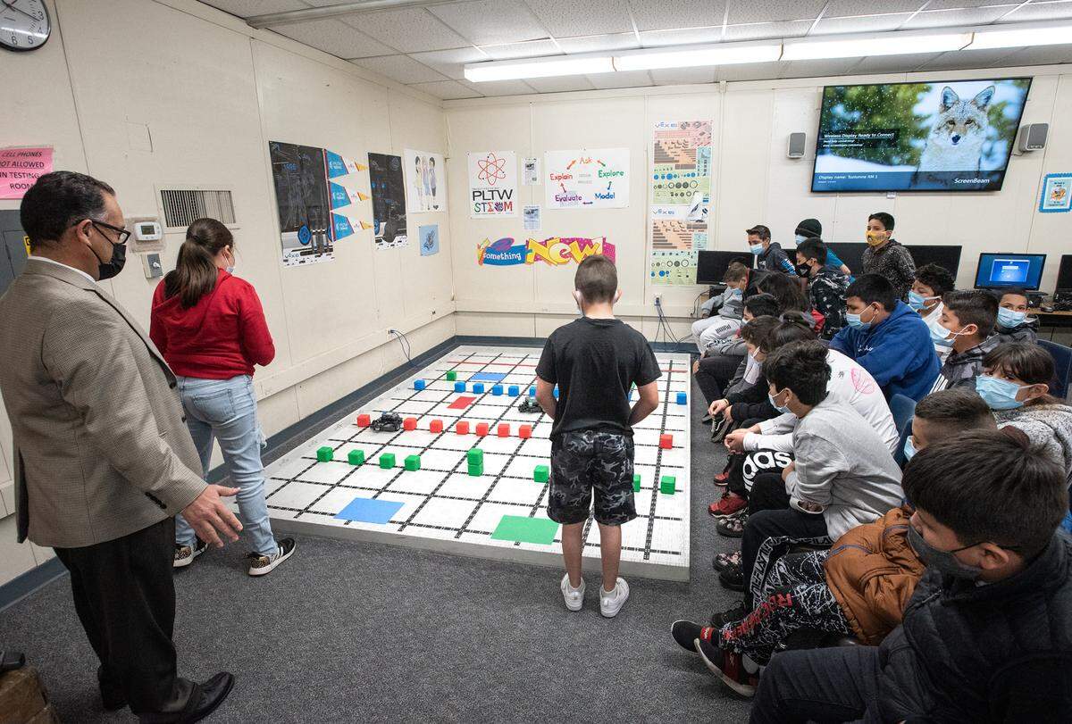 Fifth-grade teacher Hector Barraza observes his students as they drive robots through a maze during STEM class at Tuolumne Elementary School in Modesto, Calif., on Thursday, Feb.17, 2022.