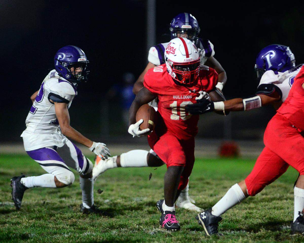 Ceres running back Tarrell Lee-Gill runs though the Pacheco defense during a game between Ceres High School and Pacheco High School at Ceres High School in Ceres California on October 7, 2022.