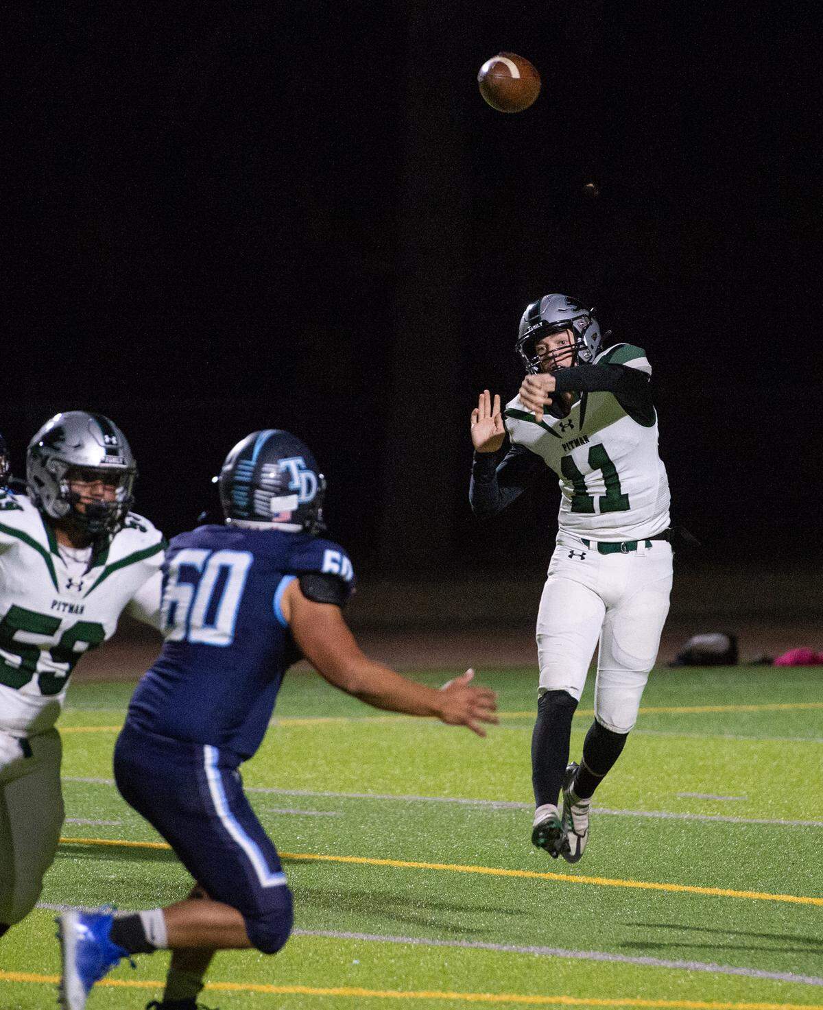 Pitman quarterback Drew Walker makes a pass during the Central California Athletic League game with Downey at Downey High School in Modesto, Calif., Friday, Oct. 28, 2022.