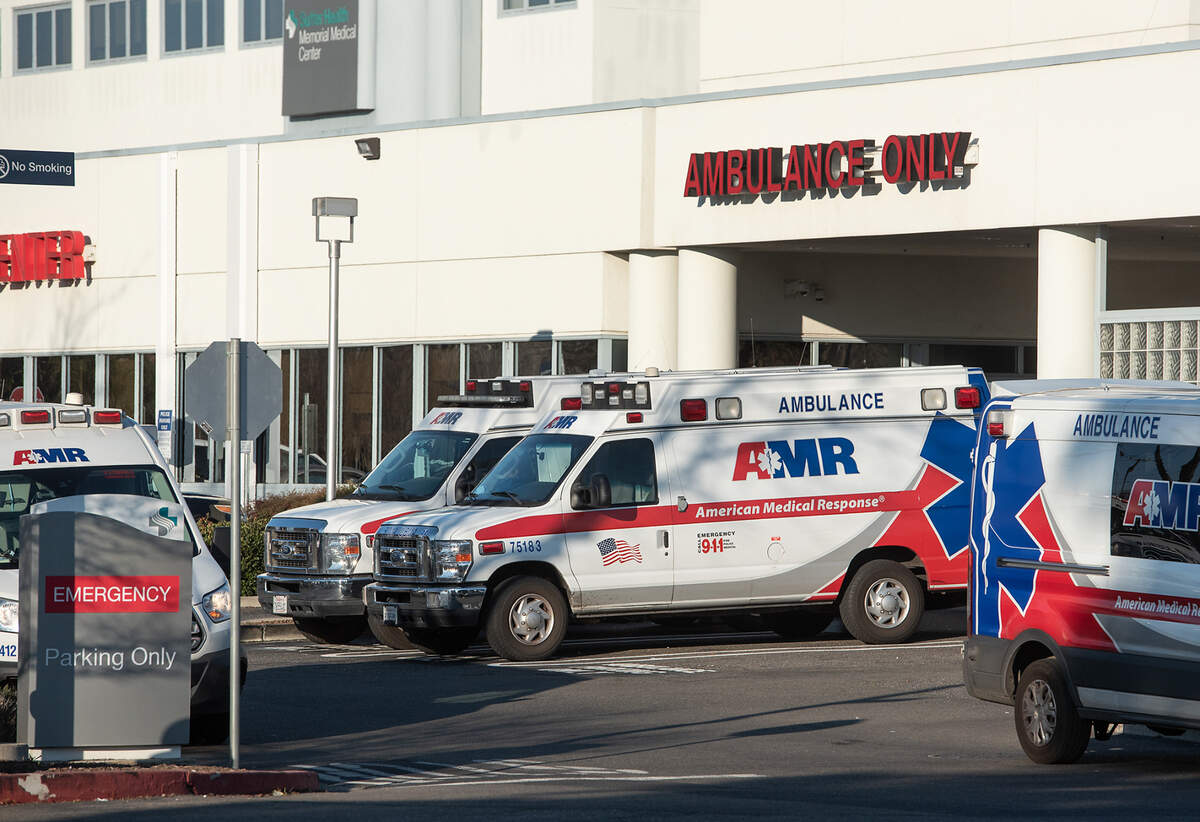 AMR ambulances are parked outside the emergency department at Sutter Memorial Medical Center in Modesto, Calif., on Tuesday, Jan. 25, 2022.