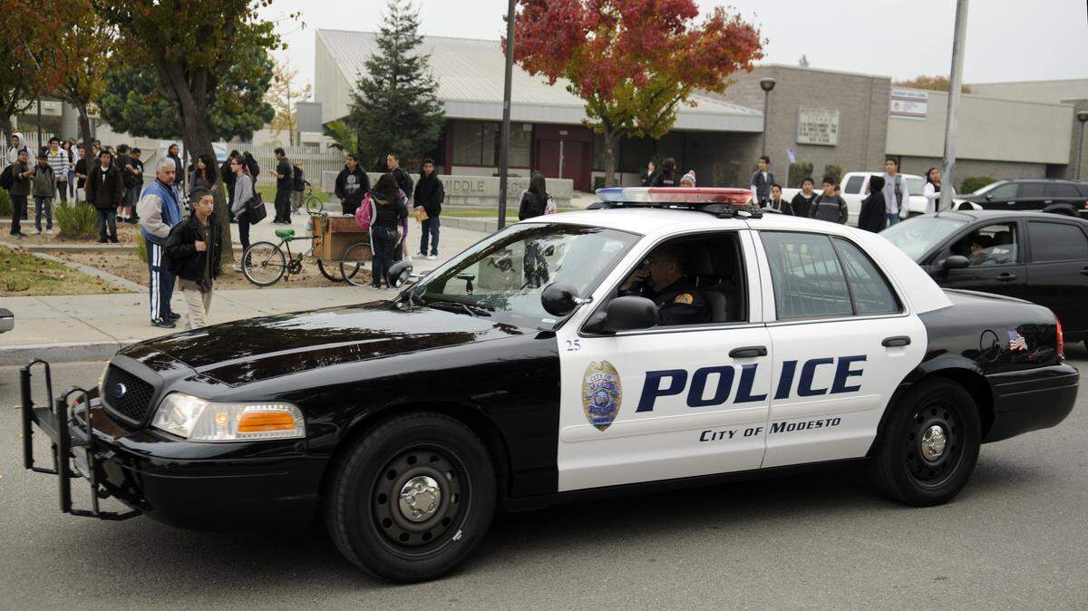 In this photo from several years ago, a Modesto police vehicle is seen in front of Hanshaw Middle School in Modesto, Calif., as students leave campus at the end of the schoolday.