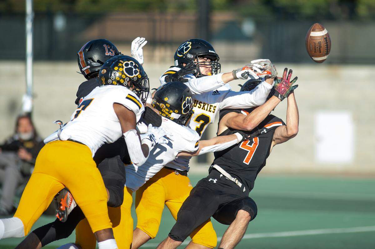 Hughson players break up a pass in the last seconds of the Sac-Joaquin Section Division VI championship game with Summerville at St. Mary’s High School in Stockton, Calif., Saturday, Nov. 26, 2022.