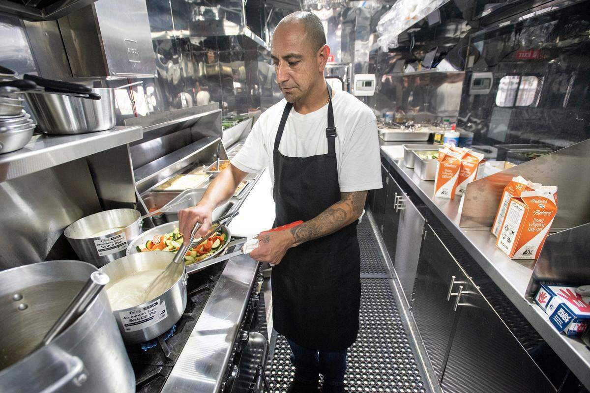 Chef Braulio Hernandez makes all his sauces from scratch at Braulio’s Bistro in Modesto ,Calif., on Thursday, Nov. 18, 2021. Hernandez cooks inside a food trailer at Grub Hubs food truck court.