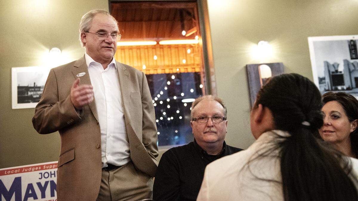 Stanislaus judge candidate John R. Mayne, left, talks with supporters Melodyrose England, 12, Sherri English, right, and Matt Pettus, middle, during an election night party at Ralston’s Goat restaurant in Modesto, Calif., on Tuesday, March. 3, 2020.