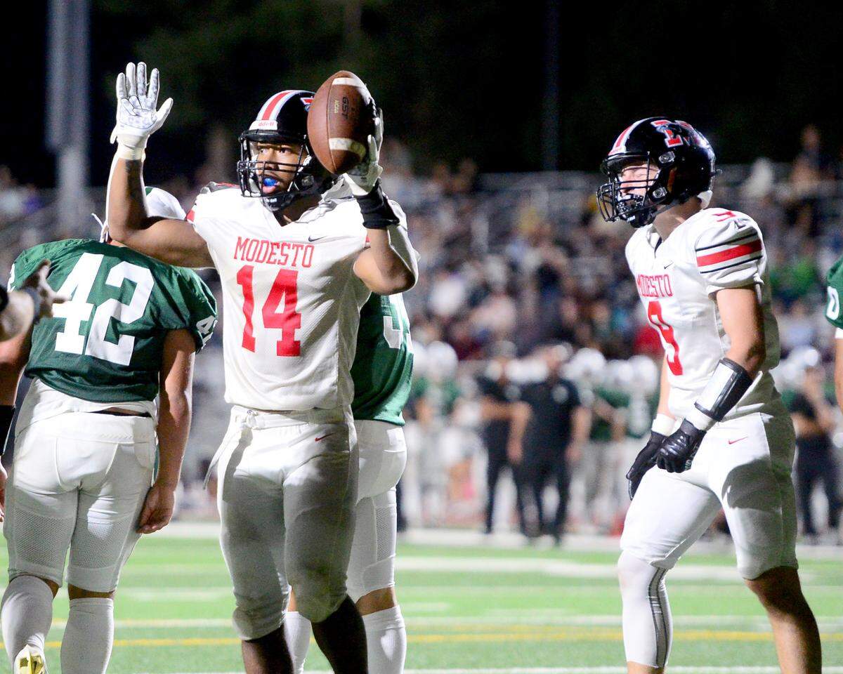 Modesto High running back Vanntheesouk ‘Lucky’ Dam (14) signals after scoring a touchdown during a game between Modesto High School and Central Valley High School at Gregori High School in Modesto, Calif., on Sept. 13, 2024.