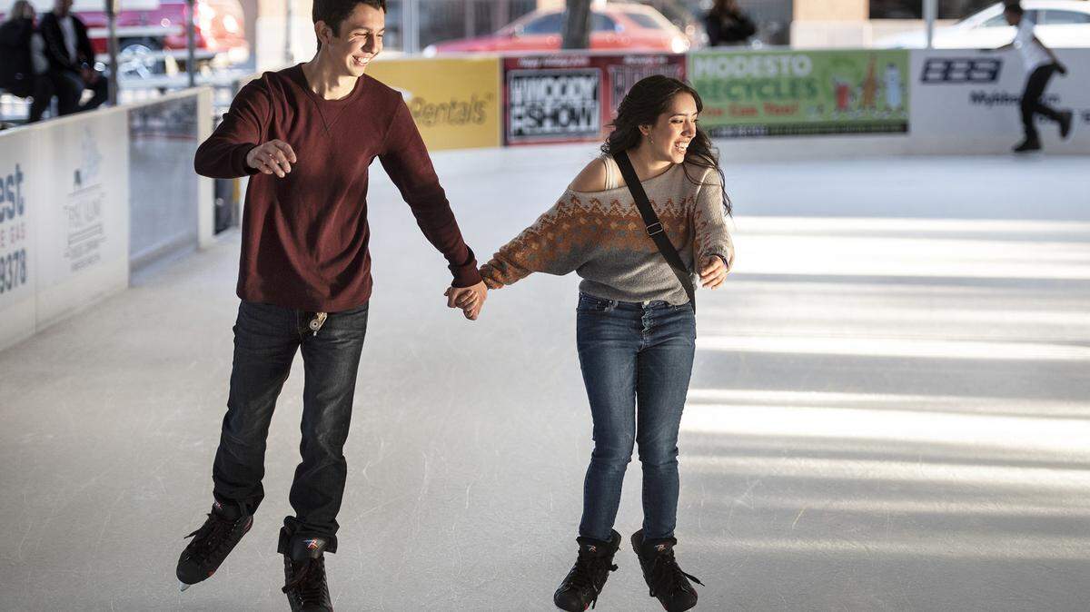 Maira Aguilar, right, and Jacob DeBoss, left, skate together at Modesto On Ice in Downtown Modesto, Calif., Saturday, Nov. 23, 2019.